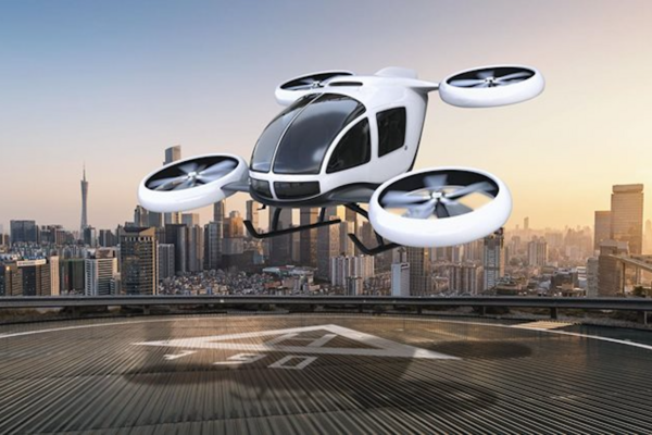 eVTOL air taxi lifting off from a rooftop vertiport above a city skyline
